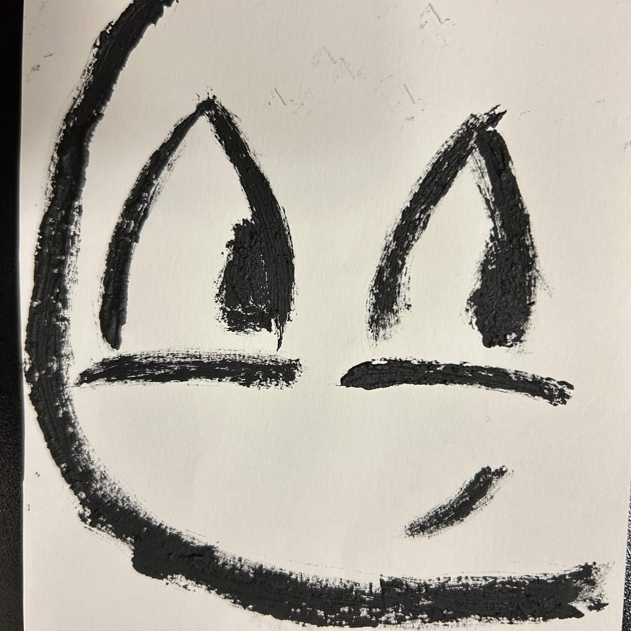Graphite painting of a cartoon face.